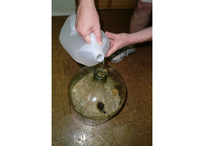 Adding spring water to total 5 gallons in carboy